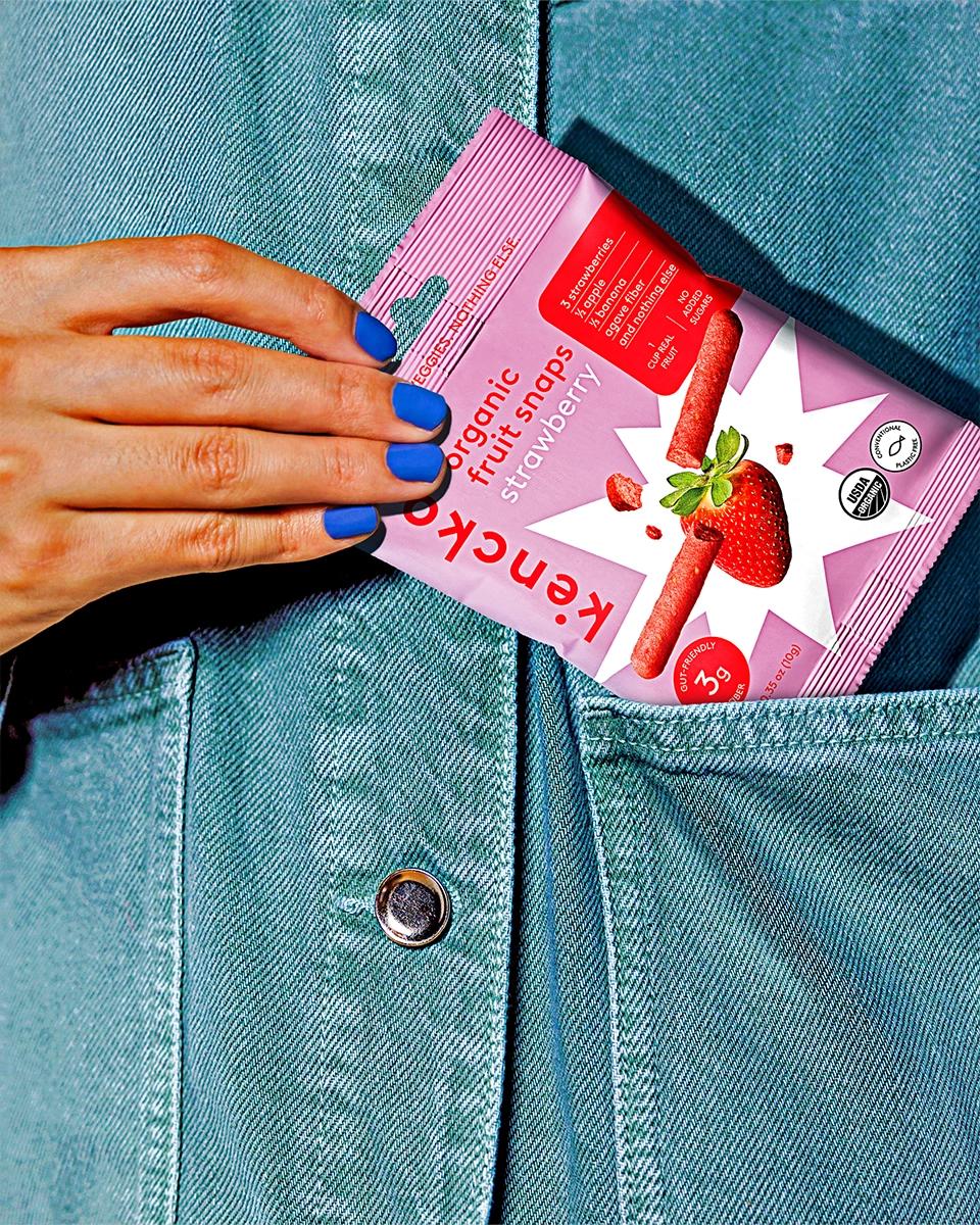 someone putting fruit snaps in their pocket